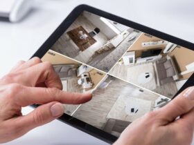 Person Monitoring CCTV Footage On Digital Tablet